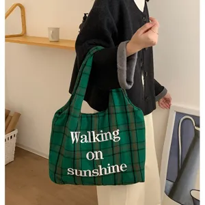 Detailed view of autumn winter wool plaid embroidered vest shopping bag lifestyle display.
