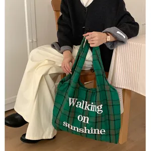 Green plaid wool tote bag with white embroidery detail, casual vintage shoulder bag accessory.