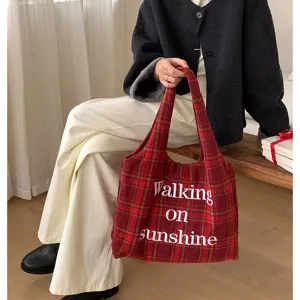 Casual winter woolen plaid tote bag with cute white embroidery detail and shoulder strap.