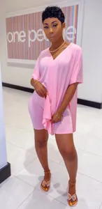 Detailed view of the stylish pink two piece outfit featuring a v neck top and shorts.