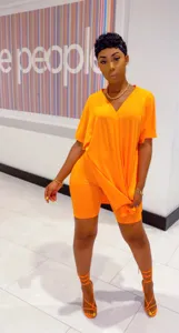 Orange V-neck batwing sleeve split top and biker shorts set outfit scene detail view.