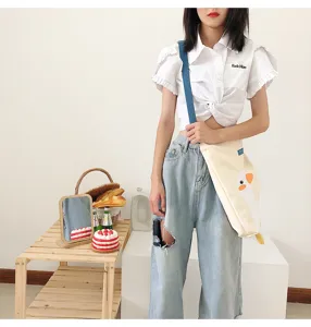 Cute yellow duck canvas shoulder bag lifestyle detail view showing casual daily fashion style.