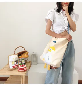 Casual canvas shoulder bag with cute yellow duck design, large capacity and stylish look.