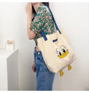 Casual canvas tote bag with cute cartoon duck print, large capacity single shoulder bag for daily use.