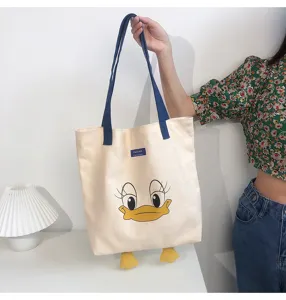 Canvas tote bag with cute cartoon duck design, large capacity casual shoulder bag for daily use.