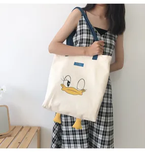 Casual large capacity canvas shoulder bag with cute cartoon duck design and contrast straps.