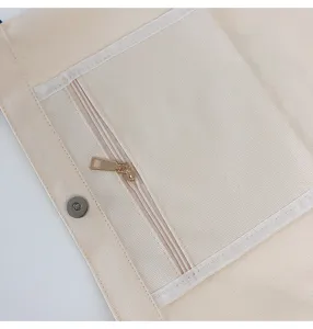 Canvas bag interior detail showing durable fabric, secure zipper pocket and magnetic snap button.