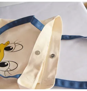 Canvas tote bag with blue straps and cute cartoon bird print, casual shoulder bag for daily use.