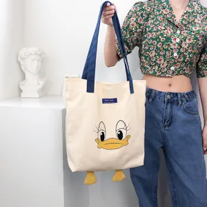 Large capacity canvas tote bag with cute cartoon duck print and contrast color design for daily use.