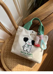 Detailed view of the cute corduroy tote bag with puppy embroidery and sturdy green handles.