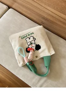 Close-up of cute corduroy handbag with puppy embroidery and green handles. Detailed design.