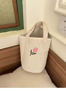 Quilted canvas bucket bag featuring cute pink tulip embroidery, casual mommy handbag detail.