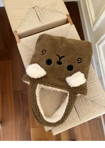 Nahaufnahme der braunen Plüschtasche mit süßem Bärengesicht und flauschigen weißen Details.