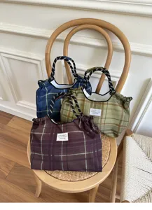 Detail view of large capacity plaid canvas bag with comfortable strap and stylish design.