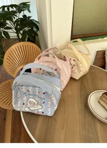 Detailansicht der isolierten Canvas-Tasche mit niedlichen Cartoon-Mustern und praktischen Henkeln.