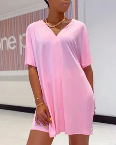 Pink V-neck oversized short sleeve top detail, casual solid color garment close-up view.