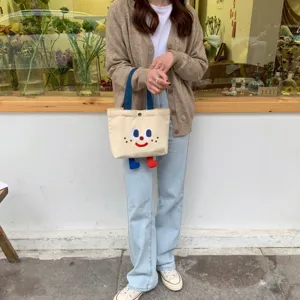 Joli sac cabas en toile avec jambes ballantes et visage de dessin animé mignon tous les jours.