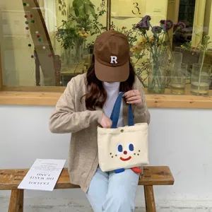 Joli sac à lunch en toile pour étudiants, petit fourre-tout esthétique avec visage.