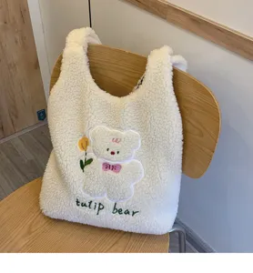 Detail shot of the cute white fluffy plush shoulder bag with sweet bear embroidery and tulip.
