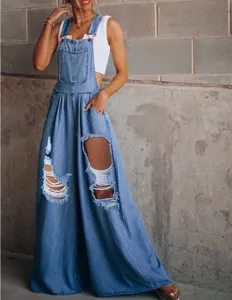 Detail view of light blue distressed denim overalls with wide legs, casual and stylish daily wear.
