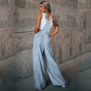Women's light blue loose casual denim overalls jumpsuit, paired with a stylish white tank top.