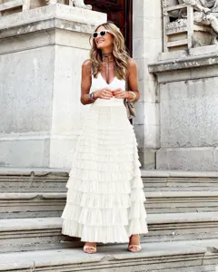 Detail shot of elegant white mesh tiered maxi skirt, summer fashion street style outfit.