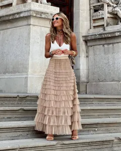 Detailed view of women summer fashion solid color mesh tiered maxi skirt and white tank top.