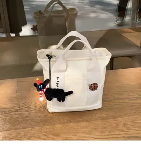 Cute canvas tote bag with zipper, compartments, black cat plush pendant and snack embroidery.