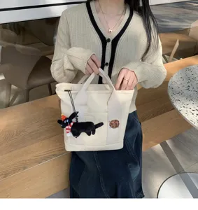 Cute canvas tote bag with puppy plush pendant and cookie embroidery for daily student use.