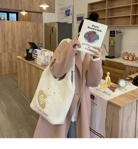 Fluffy shoulder bag detail, cute cartoon bear embroidery, warm winter plush tote style.