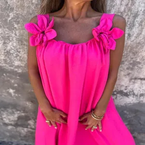 Women summer sleeveless dress with bright pink color and elegant floral shoulder straps.