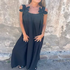 Black sleeveless long dress with floral shoulder straps, elegant summer fashion apparel detail.