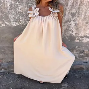 Detail view of the summer solid color long dress with cute flower strap designs and loose fit.