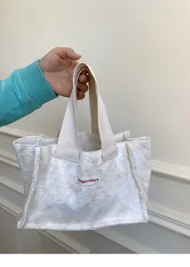 Mini canvas tote bag with floral jacquard pattern, portable handbag for daily use and travel.