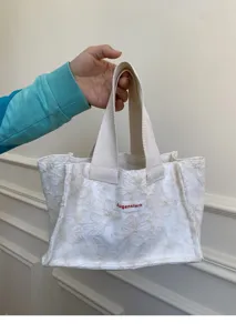 White mini canvas tote bag with floral pattern and top handles for daily casual portable use.