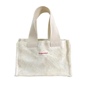 White floral jacquard mini canvas tote bag with sturdy handles, perfect for daily casual outings.