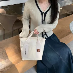Cute canvas tote bag with zipper compartment, embroidered cookie design for student daily use.