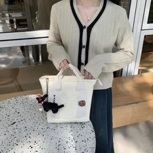Canvas tote bag with cute snack embroidery and plush dog charm, casual student handbag.