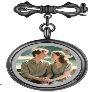 Detailed view of black metal bow brooch with round photo locket tray for custom memories.