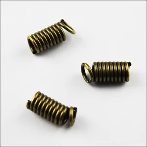 Detailed view of bronze spring end caps beads tips for DIY leather cord jewelry making.