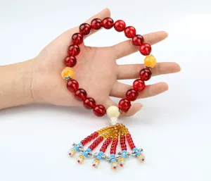 Red crystal car hanging ornament with colorful beads and tassel for auto interior decor detail.