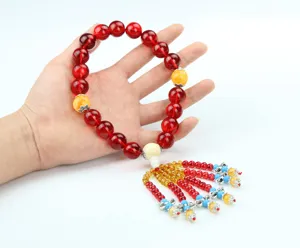 Red crystal beaded car hanging ornament with colorful tassels, traditional lucky amulet decor.