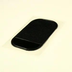 Black car anti-slip sticky dash mat silicone phone holder pad for vehicle interior accessory.