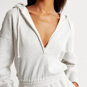 Dames lichtgrijs hooded rits jumpsuit casual lange mouw romper met taillekoord.