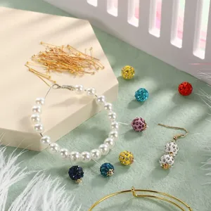 DIY jewelry making supplies, brass headpins, pearl bracelet and colorful rhinestone ball charms.