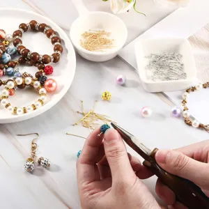 Close-up detail of DIY copper head pins and beading materials for handmade jewelry crafting.