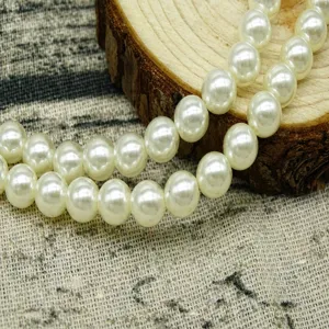 White plastic ABS pearl beads with drilled holes for DIY jewelry making and nail art design.