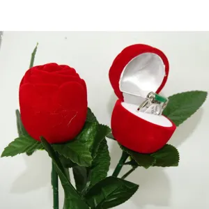 Detailed view of red velvet rose ring box with green leaves, perfect for romantic proposal gifts.