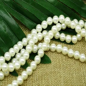Close-up view of white ABS pearl beads, perfect for nail art decoration and craft DIY projects.