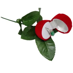 Red velvet rose flower ring box with stem for romantic proposal and anniversary jewelry display.